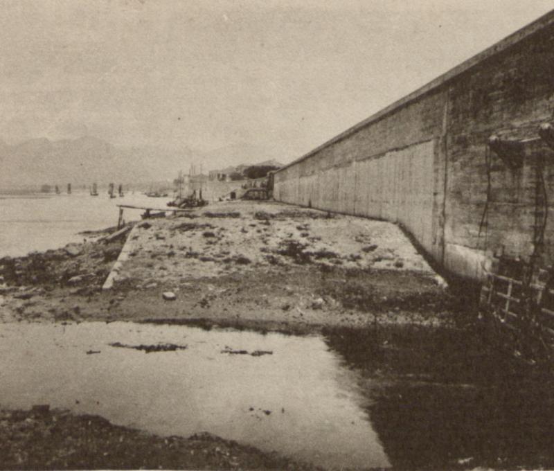 大稻埕L 型RC牆式堤防與附設的電動排水閘門（右下角）。資料來源：臺灣總督府民政部，《記念臺灣寫真帖》（臺北：臺灣總督府民政部，1915），頁29，中央研究院臺灣史研究所檔案館典藏，識別號：B0131_00_00_0030_a01。